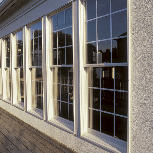 A row of large, white-framed windows on the exterior wall of a Salt Lake City home, with sunlight reflecting off the glass and a wooden deck below—perfect for showcasing quality composite window installation in Utah. A row of large, white-framed windows on the exterior wall of a Salt Lake City home, with sunlight reflecting off the glass and a wooden deck below—perfect for showcasing quality composite window installation in Utah.