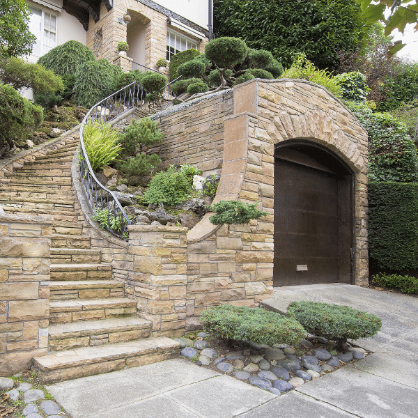 Happy Clients After Exterior Stone Remodel Homeowners standing in front of a newly remodeled stone exterior home