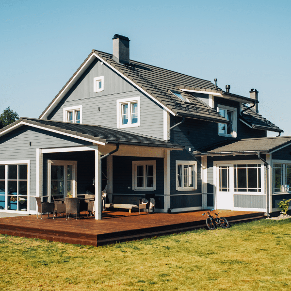 Damaged siding illustrating the cost of neglecting exterior maintenance Close up of damaged house siding showing cracks and peeling paint