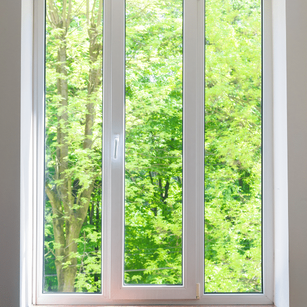 A white-framed vinyl window with three glass panels reveals green trees and bright sunlight outside—a perfect view for homes in Salt Lake City, Utah. A white-framed vinyl window with three glass panels reveals green trees and bright sunlight outside—a perfect view for homes in Salt Lake City, Utah.